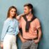 Fashion girl and guy in outlet clothes posing on a blue background