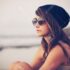 30979393-fashion-portrait-of-young-hipster-woman-with-hat-and-sunglasses-on-the-beach-at-sunset-retro-style-c